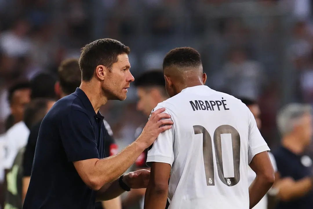 El entrenador del Real Madrid, Xabi Alonso (izquierda), habla con el jugador Kylian Mbapp&eacute; durante un partido amistoso entre el WSG Tirol y el Real Madrid, en Innsbruck, Austria, el 12 de agosto de 2025. (Futbol, Amistoso) EFE/EPA/ANNA SZILAGYI