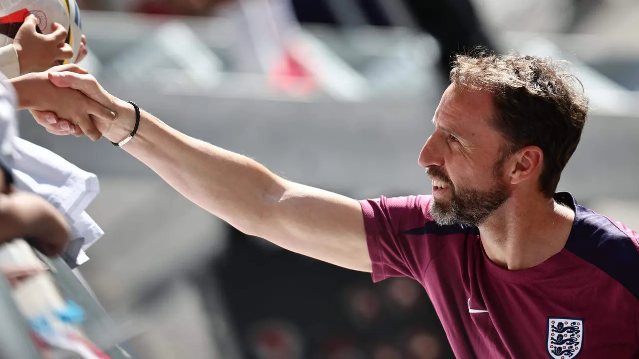 El entrenador ingl&eacute;s Gareth Southgate le da la mano a un aficionado despu&eacute;s de una sesi&oacute;n de entrenamiento abierta del equipo nacional de f&uacute;tbol ingl&eacute;s en Jena, Alemania. EFE/EPA/ANNA SZILAGYI
